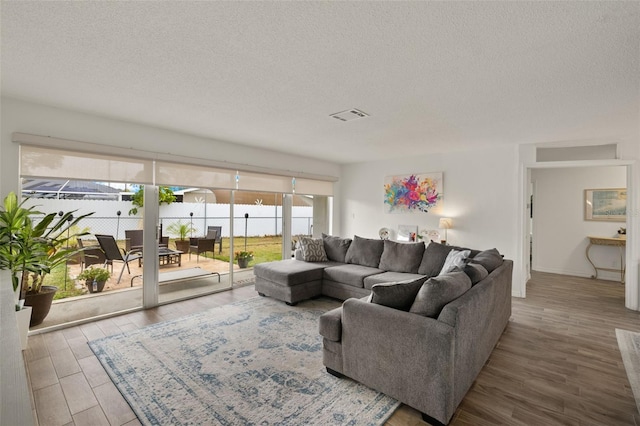 1458 Alwynne Dr N, Lehigh Acres, FL 33936 - living room with wood finished floors, a textured ceiling, and visible vents