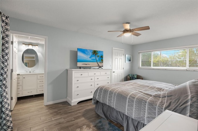 1458 Alwynne Dr N, Lehigh Acres, FL 33936 - bedroom with a ceiling fan, wood finished floors, baseboards, ensuite bathroom, and a sink