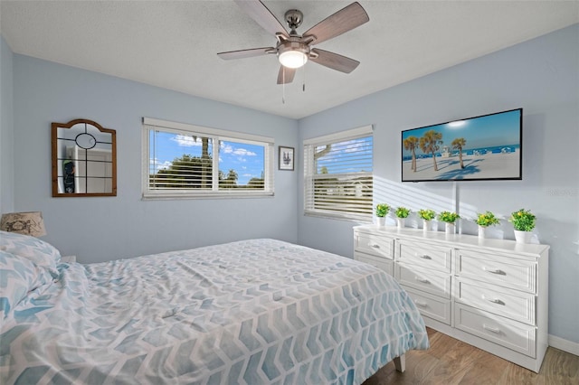 1458 Alwynne Dr N, Lehigh Acres, FL 33936 - bedroom with baseboards, ceiling fan, and light wood finished floors