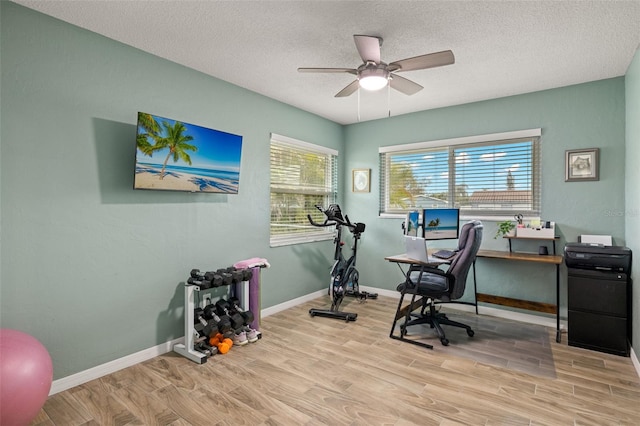1458 Alwynne Dr N, Lehigh Acres, FL 33936 - home office with baseboards, a ceiling fan, a textured ceiling, and wood finished floors