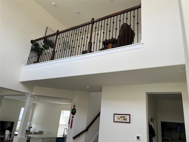5521 Summit Gln, Bradenton, FL 34203 - stairway featuring decorative columns and a towering ceiling