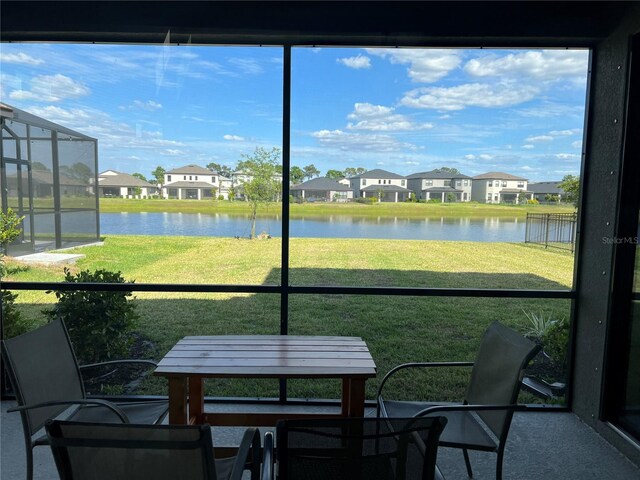 5521 Summit Gln, Bradenton, FL 34203 - sunroom / solarium with a residential view, a water view, and healthy amount of natural light