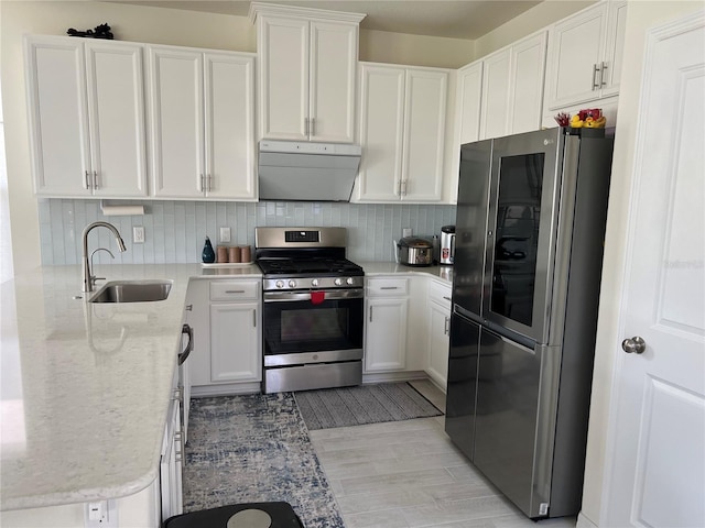 5521 Summit Gln, Bradenton, FL 34203 - kitchen with stainless steel appliances, a sink, white cabinetry, light stone countertops, and tasteful backsplash