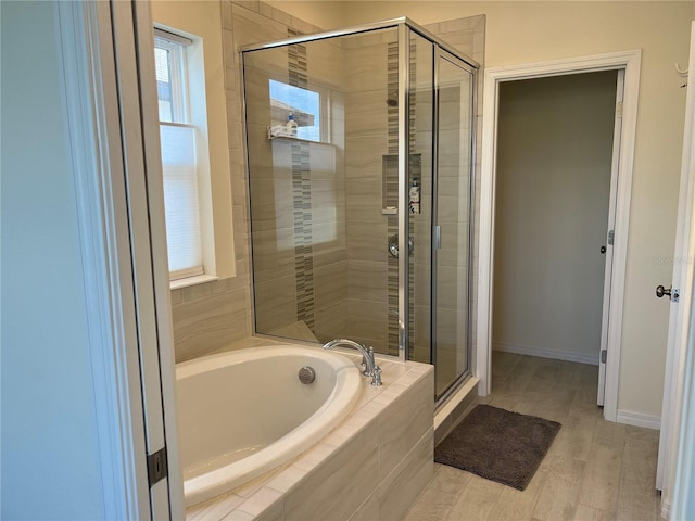 5521 Summit Gln, Bradenton, FL 34203 - full bathroom featuring a stall shower, a bath, baseboards, and wood finished floors