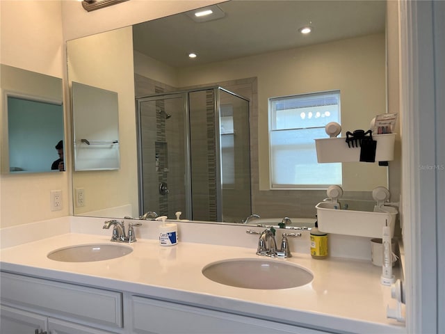 5521 Summit Gln, Bradenton, FL 34203 - bathroom with a shower stall, double vanity, and recessed lighting