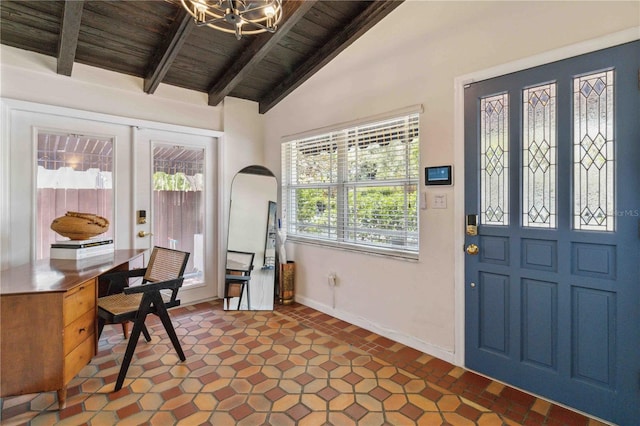 foyer entrance with baseboards, vaulted ceiling with beams, wooden ceiling, arched walkways, and a notable chandelier
