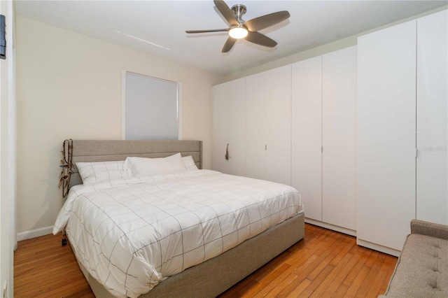 bedroom with a ceiling fan and light wood-style flooring