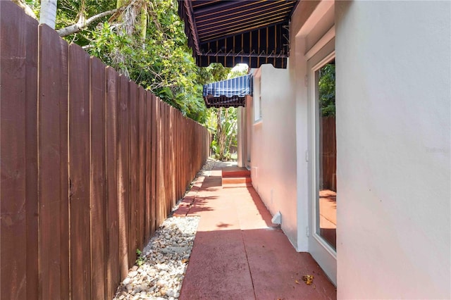 view of home's exterior with fence and stucco siding
