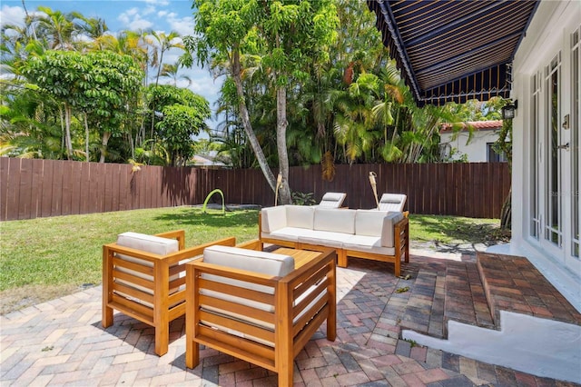 view of patio / terrace featuring outdoor lounge area, french doors, and a fenced backyard