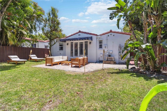 back of property with a yard, fence, an outdoor hangout area, and a patio area