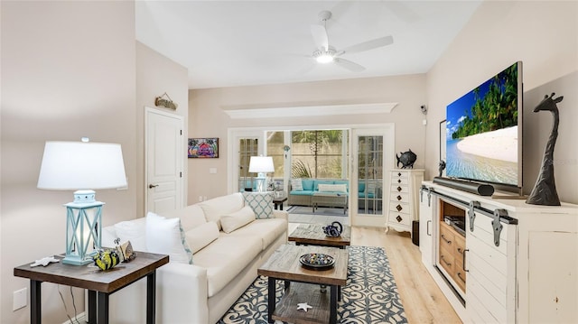 living area with a ceiling fan and light wood-style flooring