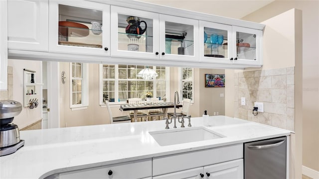 bar with stainless steel dishwasher and a sink