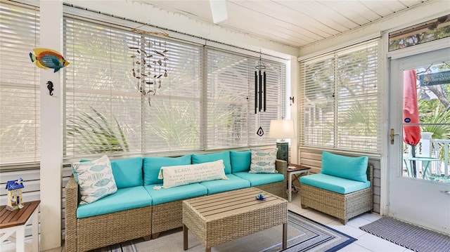 sunroom / solarium featuring tile patterned flooring, outdoor lounge area, and a healthy amount of sunlight