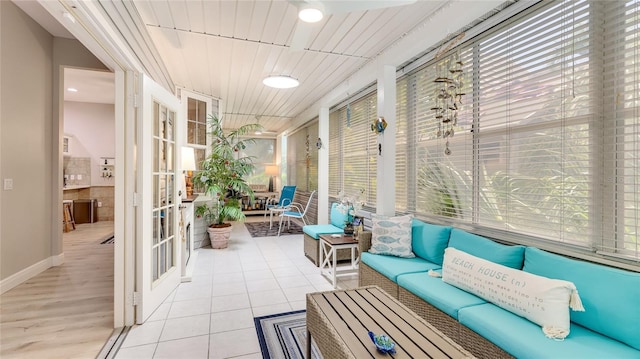 sunroom / solarium featuring outdoor lounge area and french doors
