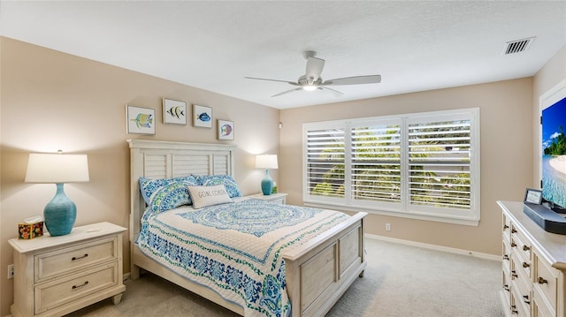 bedroom with light carpet, baseboards, a ceiling fan, and visible vents