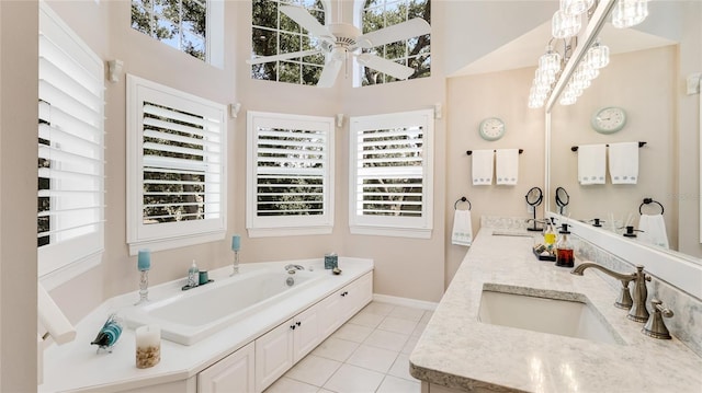 bathroom featuring a sink, ceiling fan, a healthy amount of sunlight, and tile patterned floors