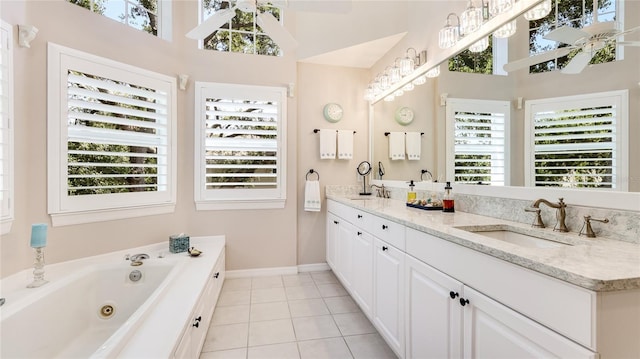 bathroom featuring a high ceiling, a sink, a whirlpool tub, tile patterned floors, and baseboards