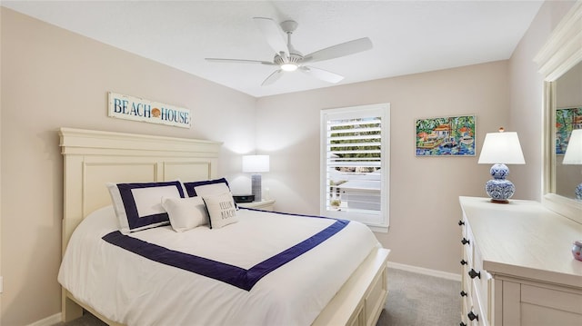 bedroom with light colored carpet, baseboards, and a ceiling fan
