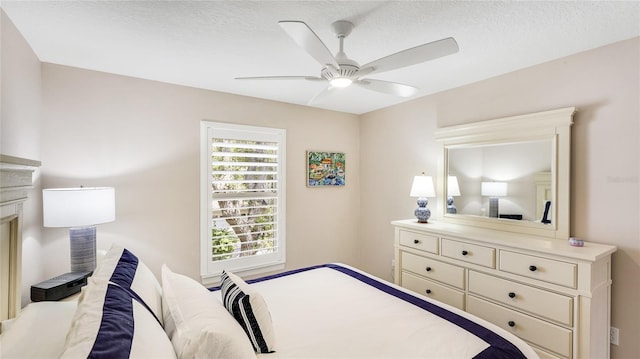 bedroom with a textured ceiling and a ceiling fan