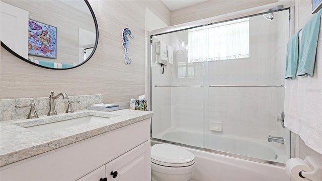 full bathroom with toilet, vanity, and combined bath / shower with glass door