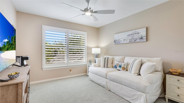 living room with baseboards, carpet flooring, and ceiling fan