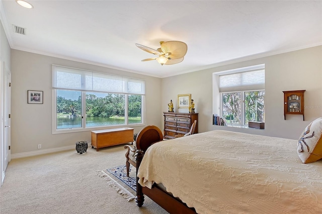 carpeted bedroom with multiple windows, crown molding, baseboards, and ceiling fan