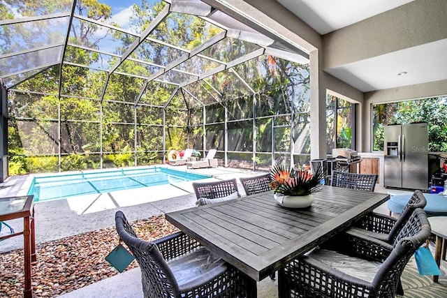 outdoor pool featuring grilling area, glass enclosure, a patio area, and outdoor dining space