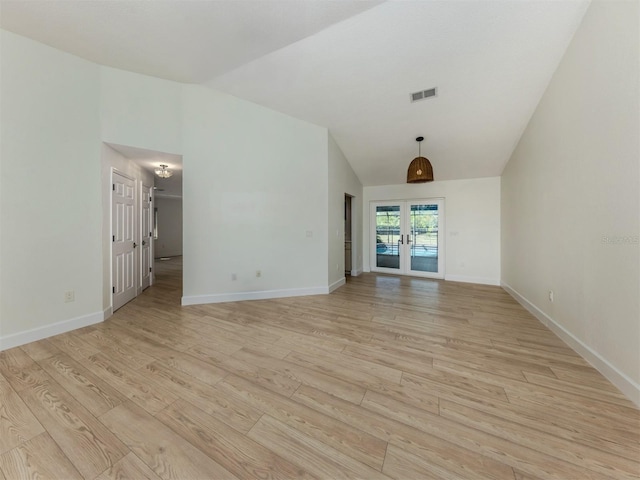 245 Woodingham Trl, Venice, FL 34292 - empty room featuring french doors, vaulted ceiling, light wood-style flooring, and baseboards