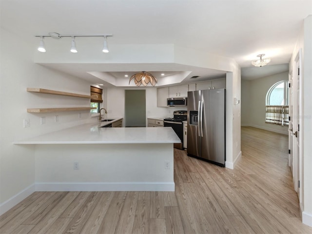 245 Woodingham Trl, Venice, FL 34292 - kitchen featuring appliances with stainless steel finishes, a chandelier, a peninsula, light countertops, and light wood finished floors