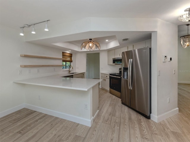 245 Woodingham Trl, Venice, FL 34292 - kitchen with appliances with stainless steel finishes, a sink, a peninsula, a chandelier, and light countertops
