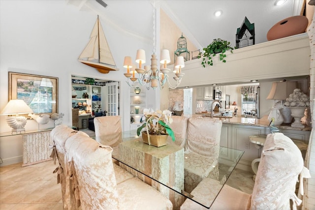 dining space featuring high vaulted ceiling, a chandelier, ornamental molding, and baseboards