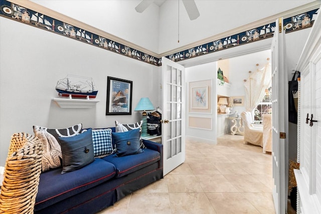 tiled living area featuring ceiling fan and french doors