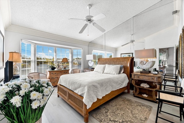 bedroom featuring crown molding, vaulted ceiling, a textured ceiling, and visible vents