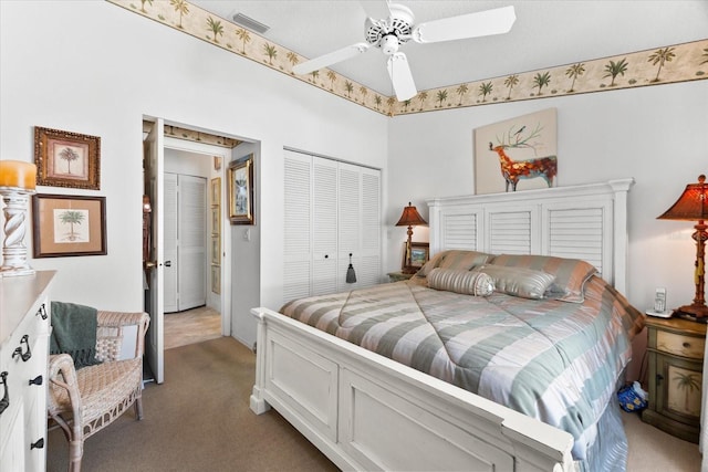 bedroom with dark colored carpet, a ceiling fan, visible vents, and a closet