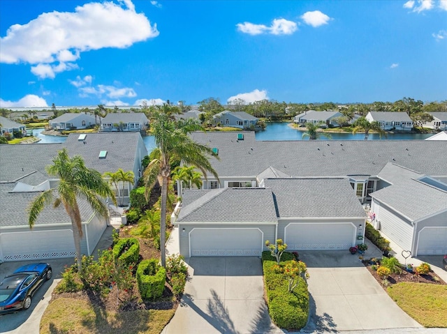 drone / aerial view featuring a water view and a residential view