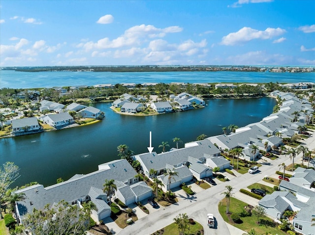 drone / aerial view with a water view and a residential view