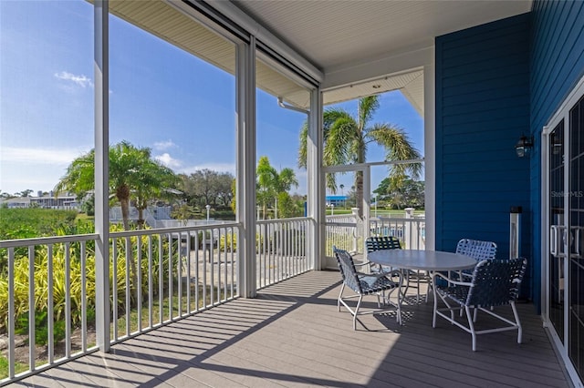 sunroom with plenty of natural light and outdoor dining area