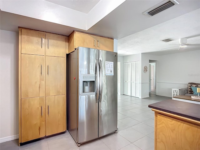 6012 11th Ave W, Bradenton, FL 34209 - kitchen with light tile patterned flooring, stainless steel fridge, visible vents, and light brown cabinetry