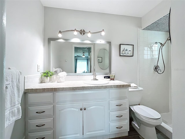 6012 11th Ave W, Bradenton, FL 34209 - full bathroom with vanity, toilet, a ceiling fan, and a tile shower