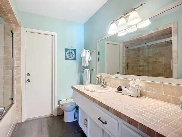 6012 11th Ave W, Bradenton, FL 34209 - full bathroom with enclosed tub / shower combo, vanity, toilet, and tile patterned floors