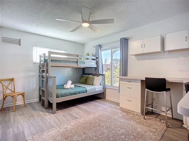 6012 11th Ave W, Bradenton, FL 34209 - bedroom featuring light wood-type flooring, baseboards, ceiling fan, and a textured ceiling