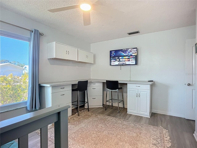 6012 11th Ave W, Bradenton, FL 34209 - office area with a ceiling fan, a textured ceiling, visible vents, wood finished floors, and built in desk