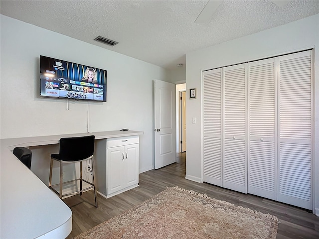6012 11th Ave W, Bradenton, FL 34209 - home office with a textured ceiling, baseboards, visible vents, and wood finished floors