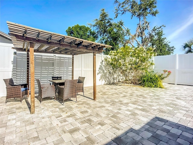 6012 11th Ave W, Bradenton, FL 34209 - view of patio / terrace with a fenced backyard, a pergola, and outdoor dining space