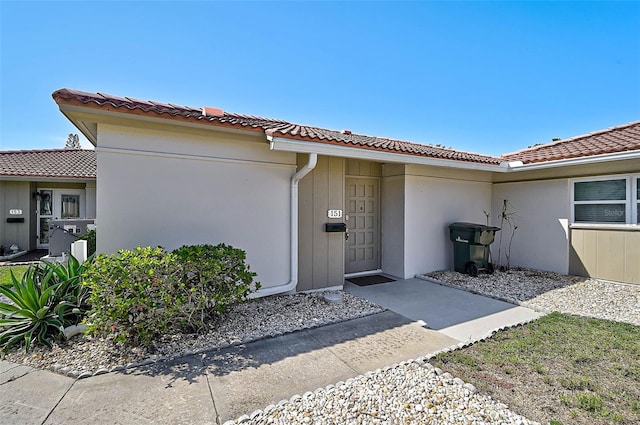 151 Vista Hermosa Cir Unit 31C, Sarasota, FL 34242 - doorway to property with a tiled roof and stucco siding