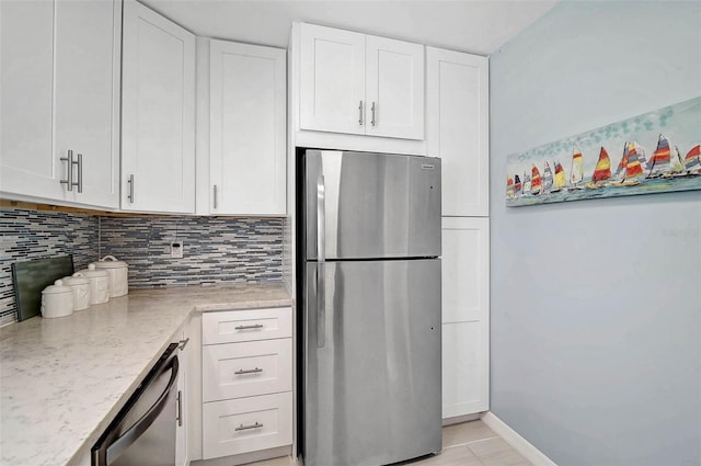 151 Vista Hermosa Cir Unit 31C, Sarasota, FL 34242 - kitchen featuring stainless steel appliances, white cabinets, backsplash, and light stone countertops