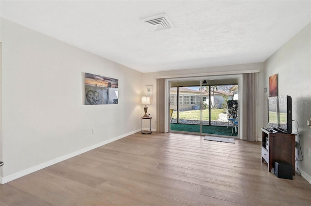 151 Vista Hermosa Cir Unit 31C, Sarasota, FL 34242 - unfurnished living room with wood finished floors and baseboards