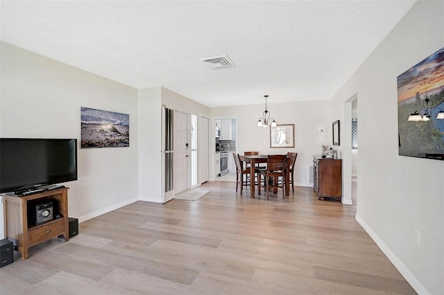 151 Vista Hermosa Cir Unit 31C, Sarasota, FL 34242 - dining space with a chandelier, light wood-style flooring, and baseboards