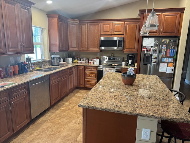 7286 Mineola Rd, Englewood, FL 34224 - kitchen featuring appliances with stainless steel finishes, a sink, a kitchen breakfast bar, light stone counters, and lofted ceiling