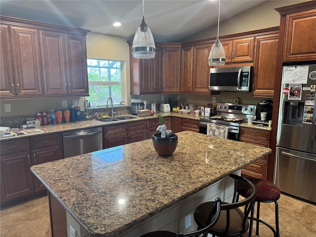 7286 Mineola Rd, Englewood, FL 34224 - kitchen with appliances with stainless steel finishes, a sink, a kitchen bar, light stone countertops, and vaulted ceiling